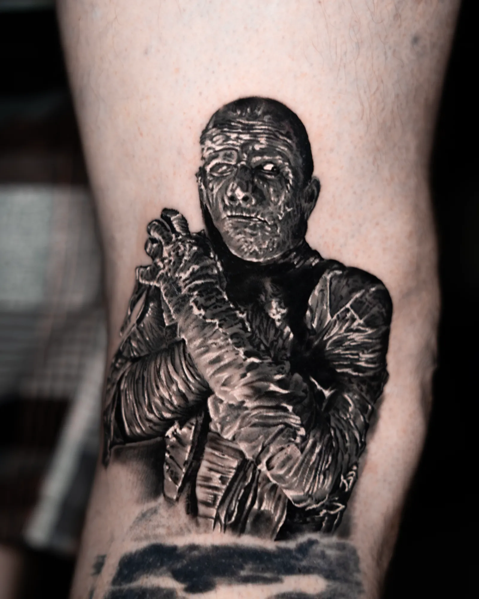 A calf: a bandaged figure with wrapped arms, holding a blade