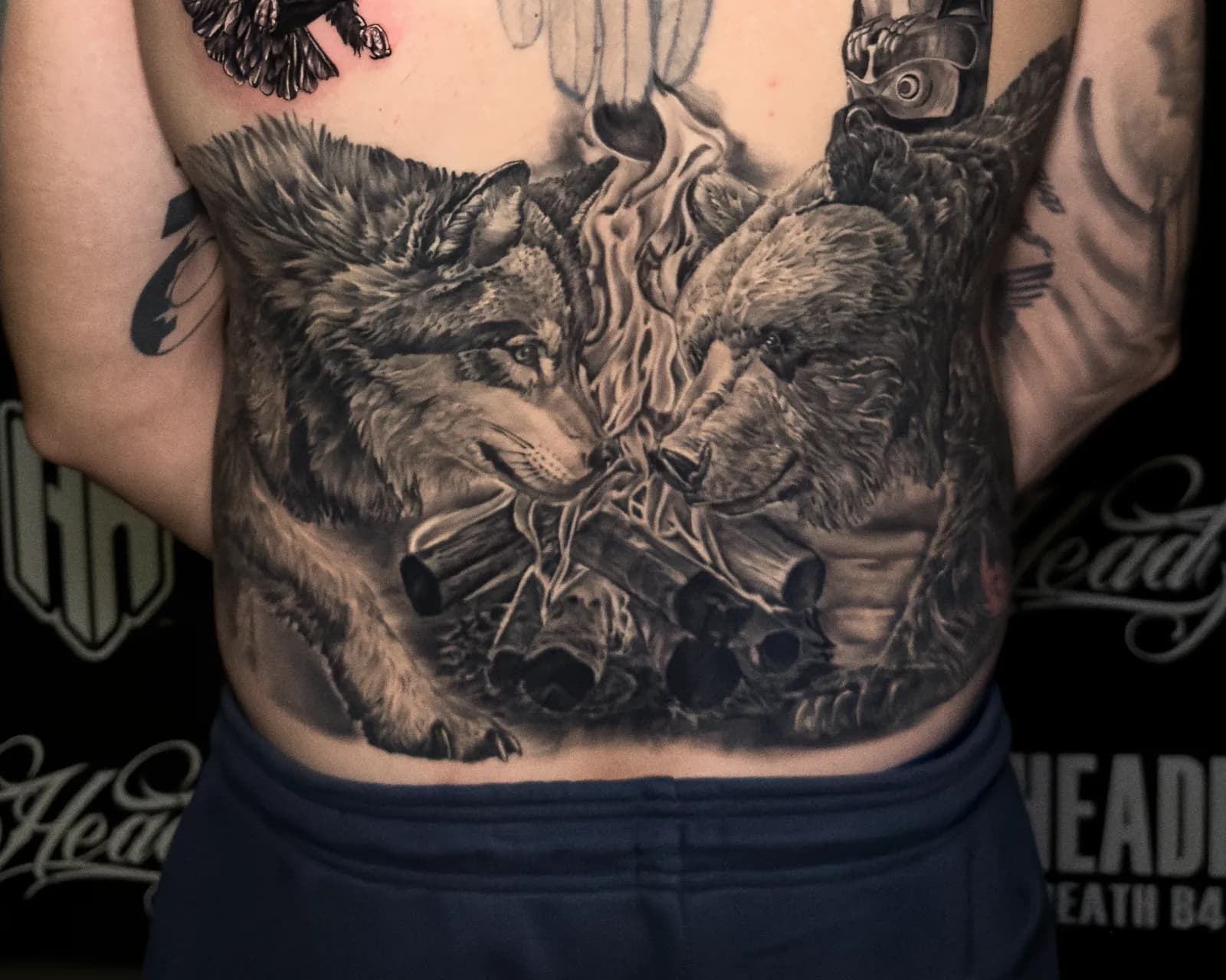 A healed lower back: a wolf and a bear facing each other across a campfire